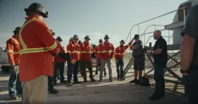 MSTs gather near a heavy-duty conveyor specifically set up for training purposes, ready to properly install new equipment.